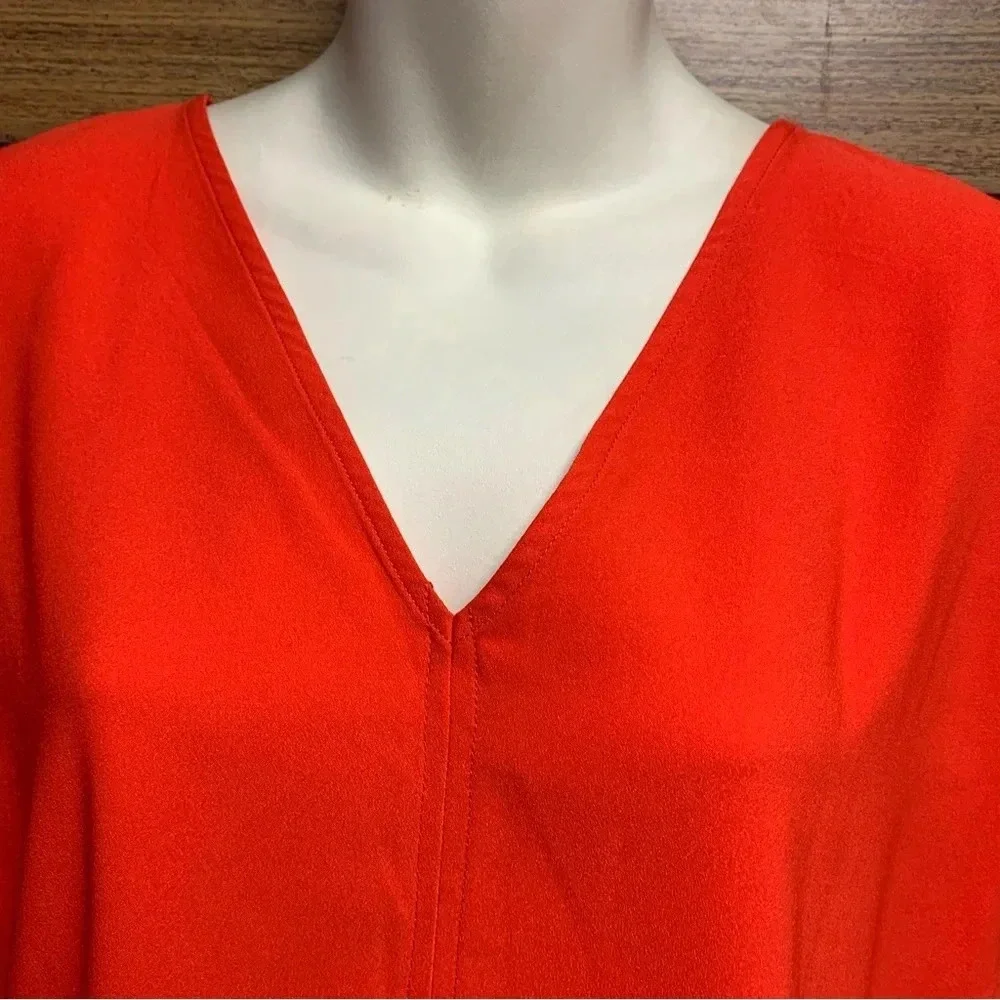 Rachel Zoe bright orange blouse size Small bold seam down the front